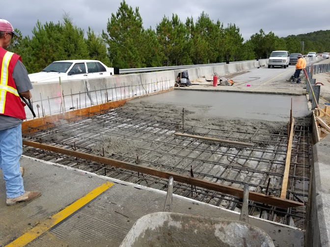 Concrete being poured on bridge construction